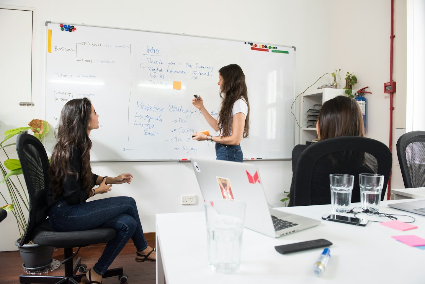 Team collaborates on marketing strategy presentation in modern office.